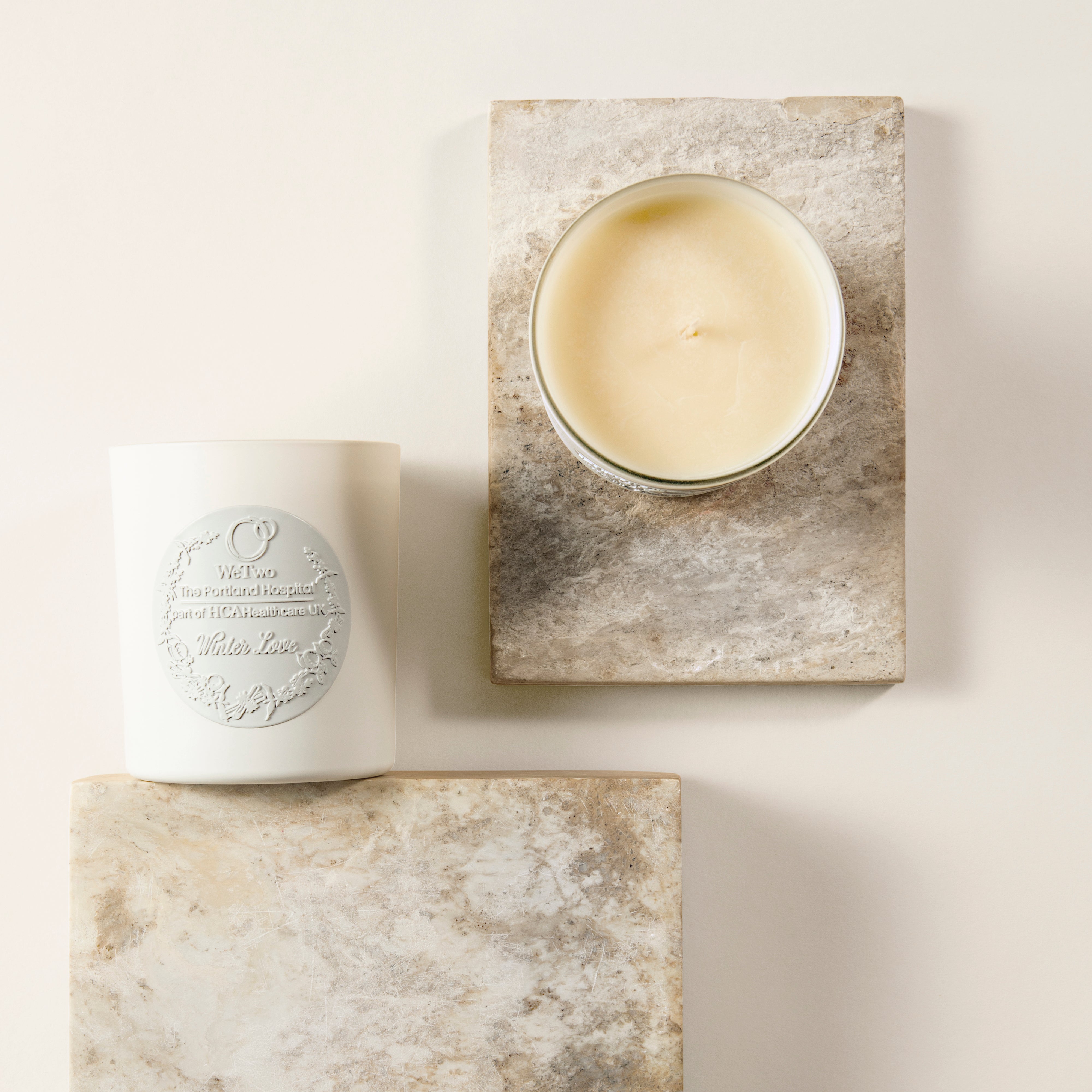WeKind White Jasmine Candle arranged on some natural stone